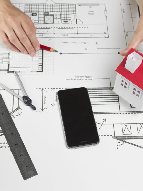 female-hand-holding-model-house-blueprint-office female-hand-holding-model-house-blueprint-office